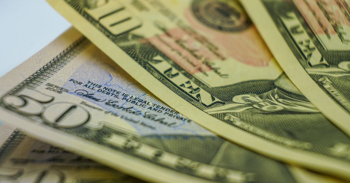 Close-up view of multiple American dollar bills showcasing finance and currency details.